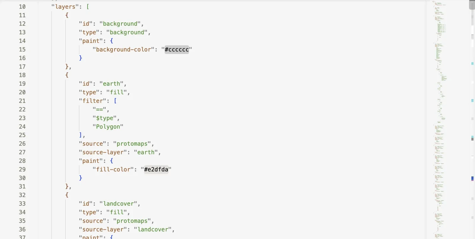 A style.json open in a code editor: the layers array, with background and earth layers expanded to show their paint colors, and a minimap showing how far the file scrolls on.